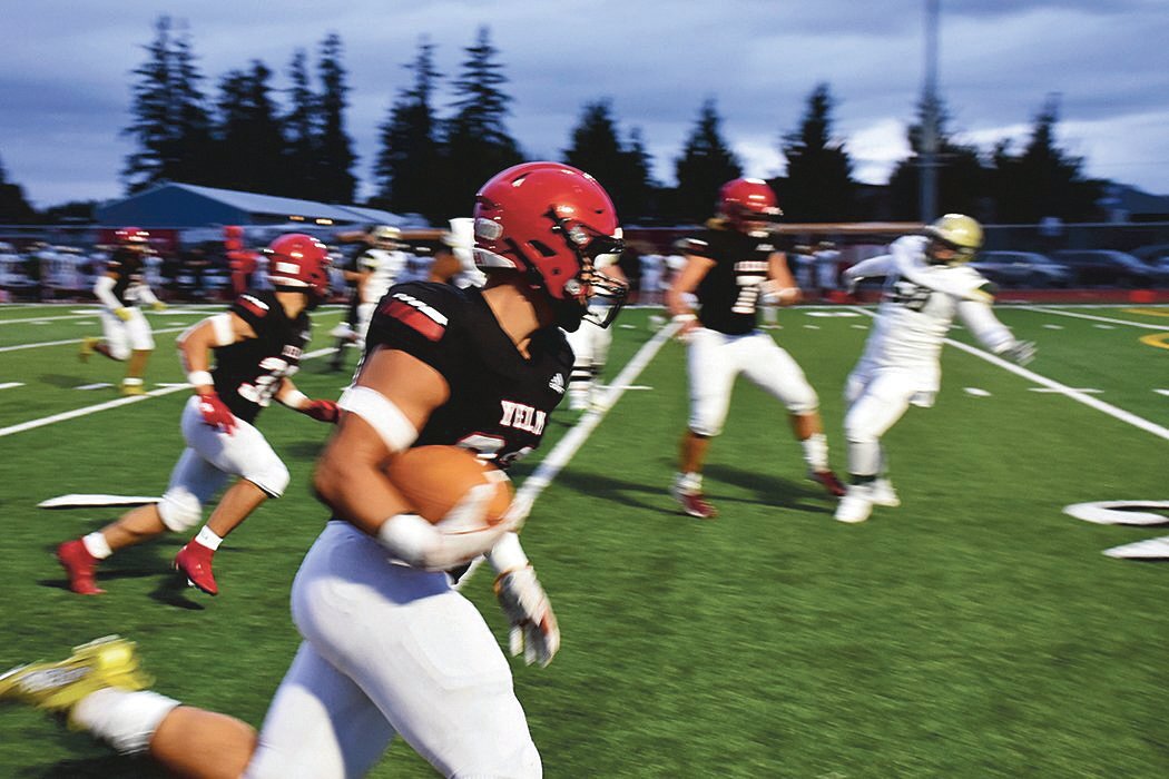 Brayden Platt runs an interception to the end zone for a pick-6 during the first quarter in the Yelm victory again Toledo High School on Friday, Sept. 17, 2021.